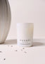 CANOPY SKINCARE LAVENDER CANDLE FRESH COLOURS WILD MOSS IN HOME SETTING NEXT TO VASE