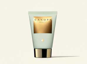 Tube of Canopy Beauty product on a light beige background