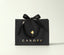 Black gift bag with a bow and 'Canopy' logo on a white background
