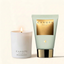 A lit white candle and a pale mint-green squeeze tube from Canopy Beauty, both with gold labels, set against a warm off-white background.