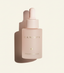 Pink skincare dropper bottle labeled 'CANOPY' on a light beige background