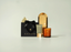 CANOPY product set with black gift bag, gold candle, and skincare item on a light background